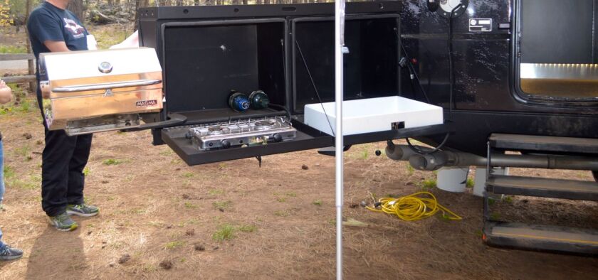 The tailgater option includes an external swing-out kitchen with grill, stove and sink