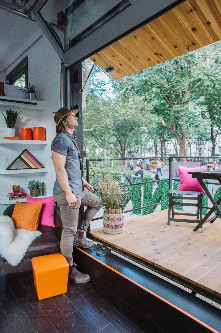 The Home That Runs on Dunkin' opens up to the porch area with garage-style lifting door