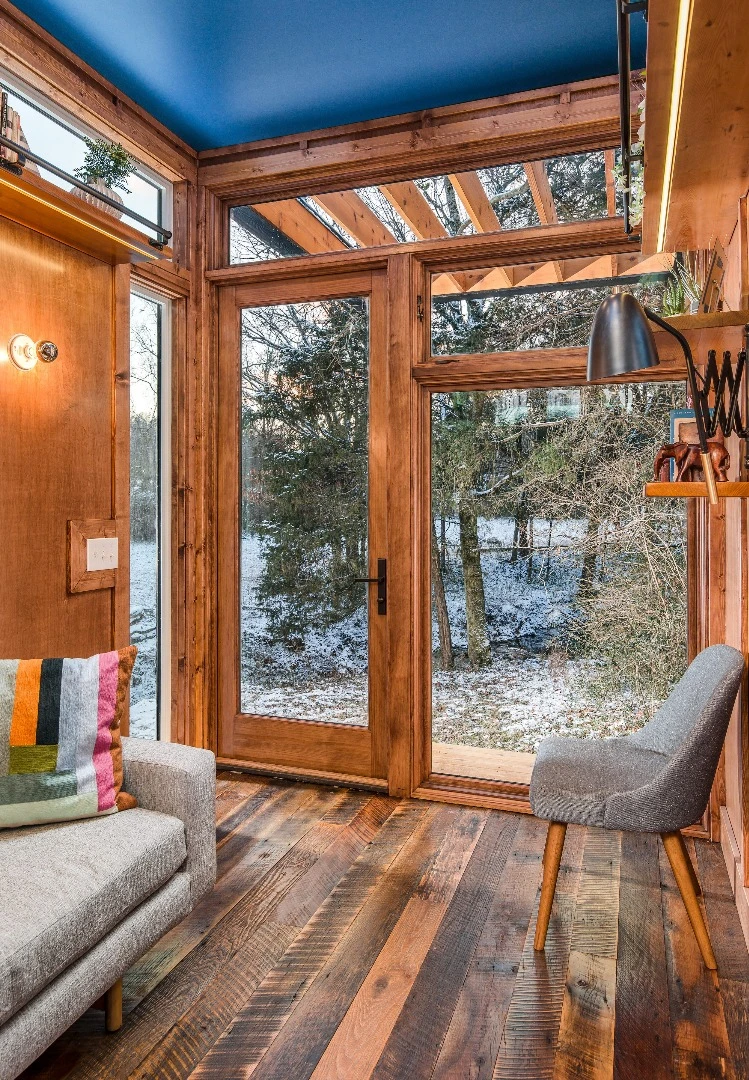 The Cornelia tiny house features reclaimed hardwood flooring, along with solid maple and maple plywood walls and ceiling inside