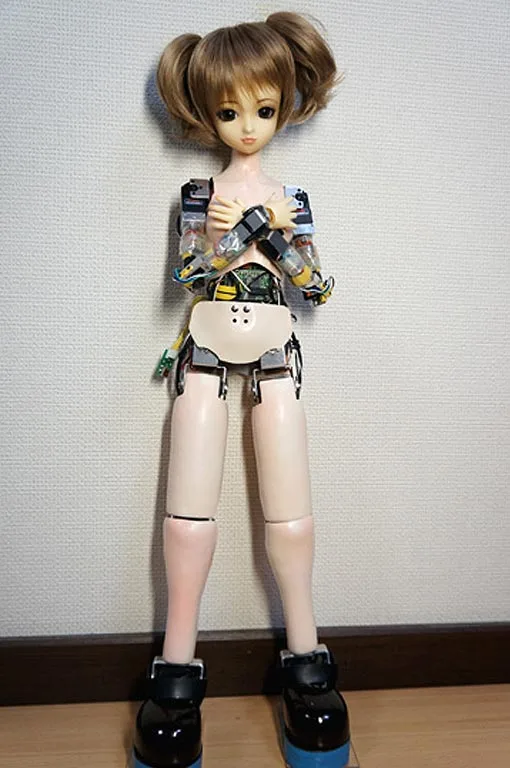 A bashful Dancing Doll RZ robot doll without its clothing shows some of its robotic parts