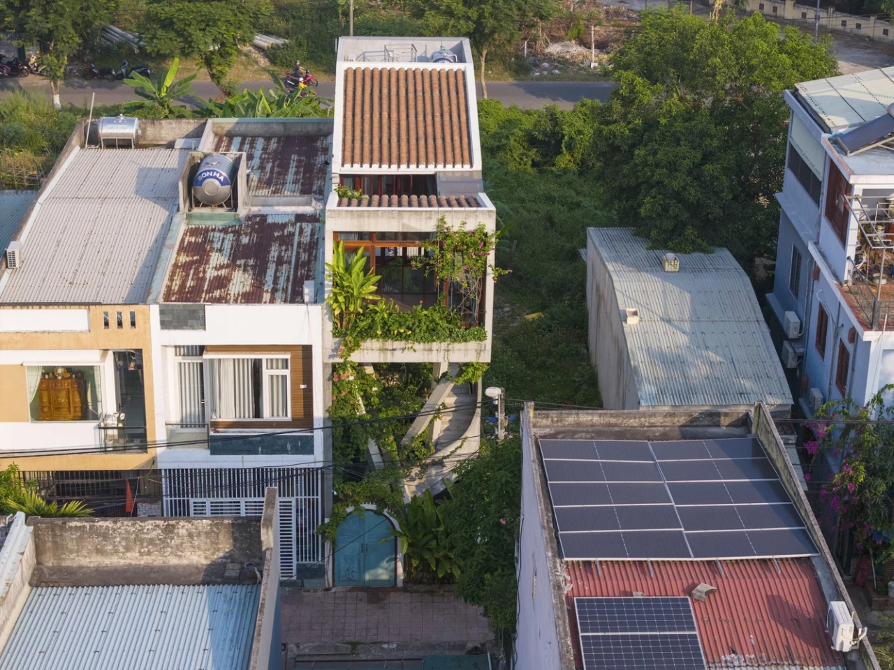 Elevated on x-shaped pillars, the three-story structure appears to float above its landscape