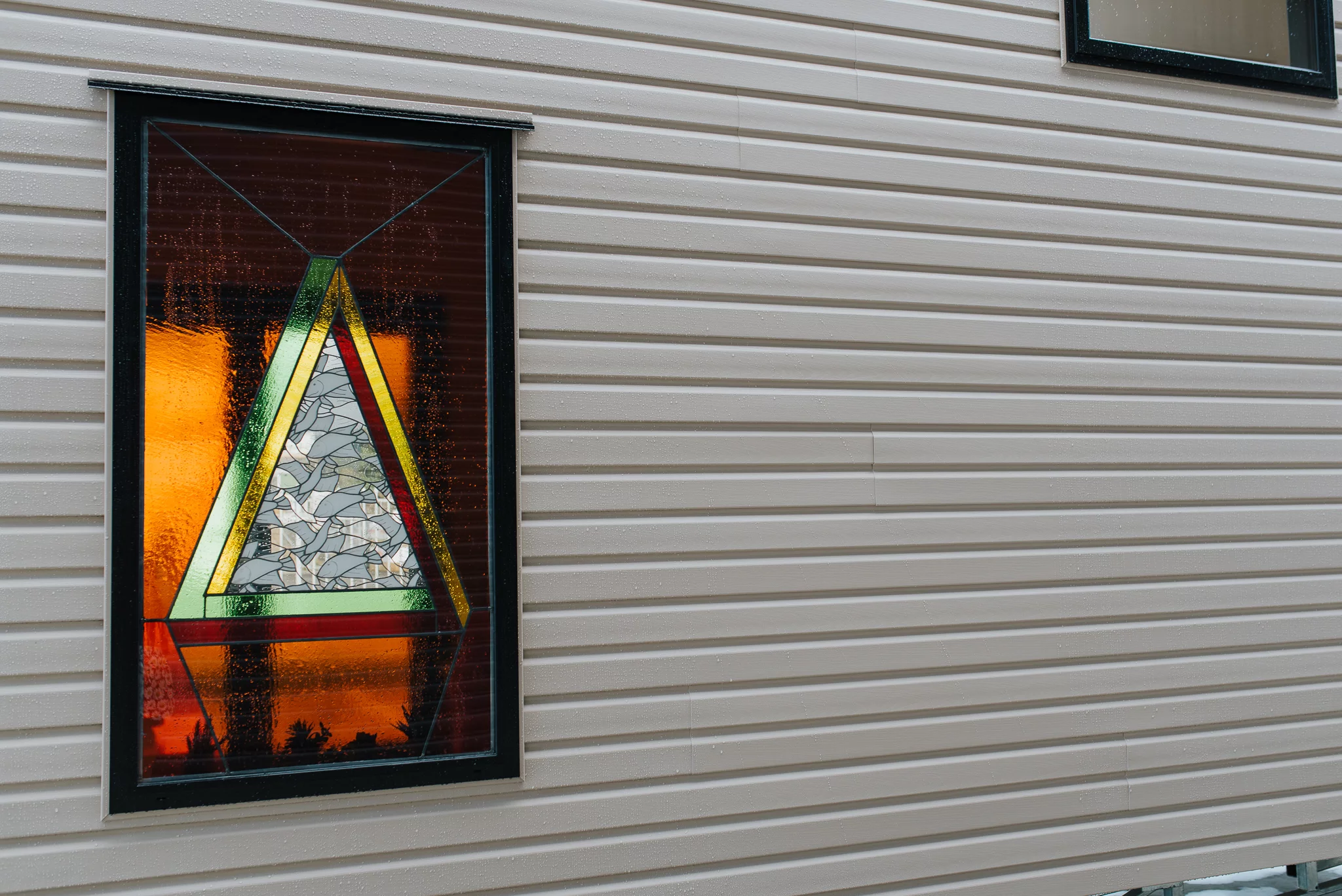 The Daisy Vera Tiny House's stained glass window is a family heirloom, and was previously installed in two homes before this one