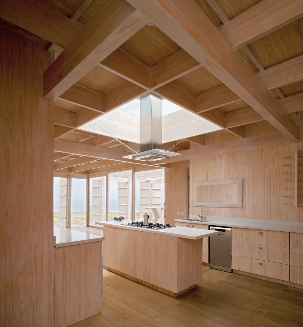 The House in Morrillos' kitchen features beams arranged so as to provide a large skylight
