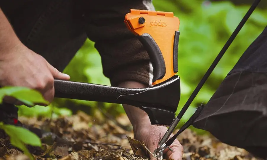 A mallet knocks in tent stakes