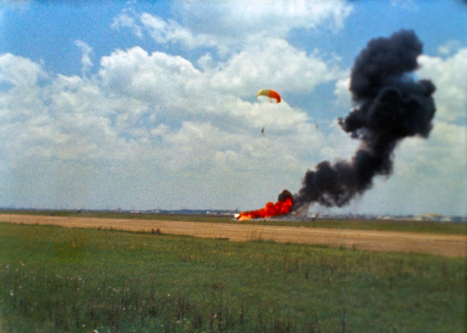 Armstrong parachuting down by the wreckage of the LLRV