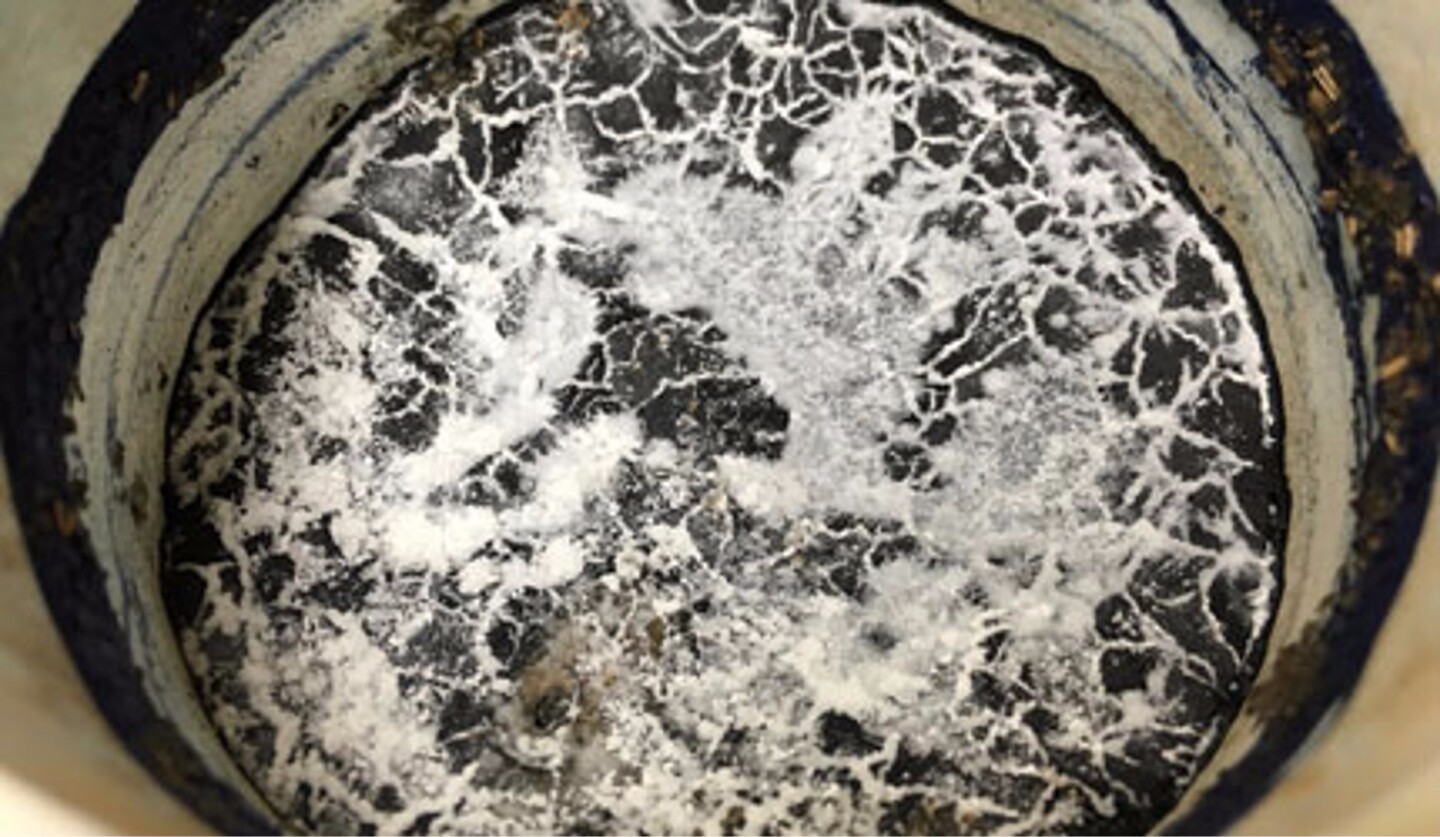 Salt forming a crust on brine-contaminated soil