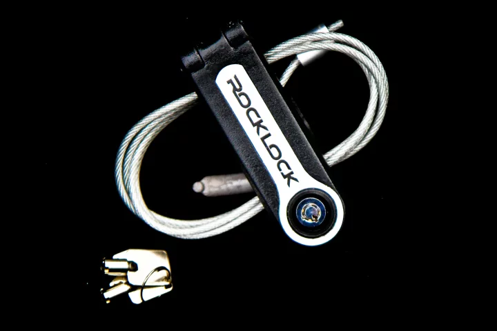 The Rock Lock loops a steel cable through any solid fixture or heavy equipment and then secures a guitar to it courtesy of a locking mechanism around the neck