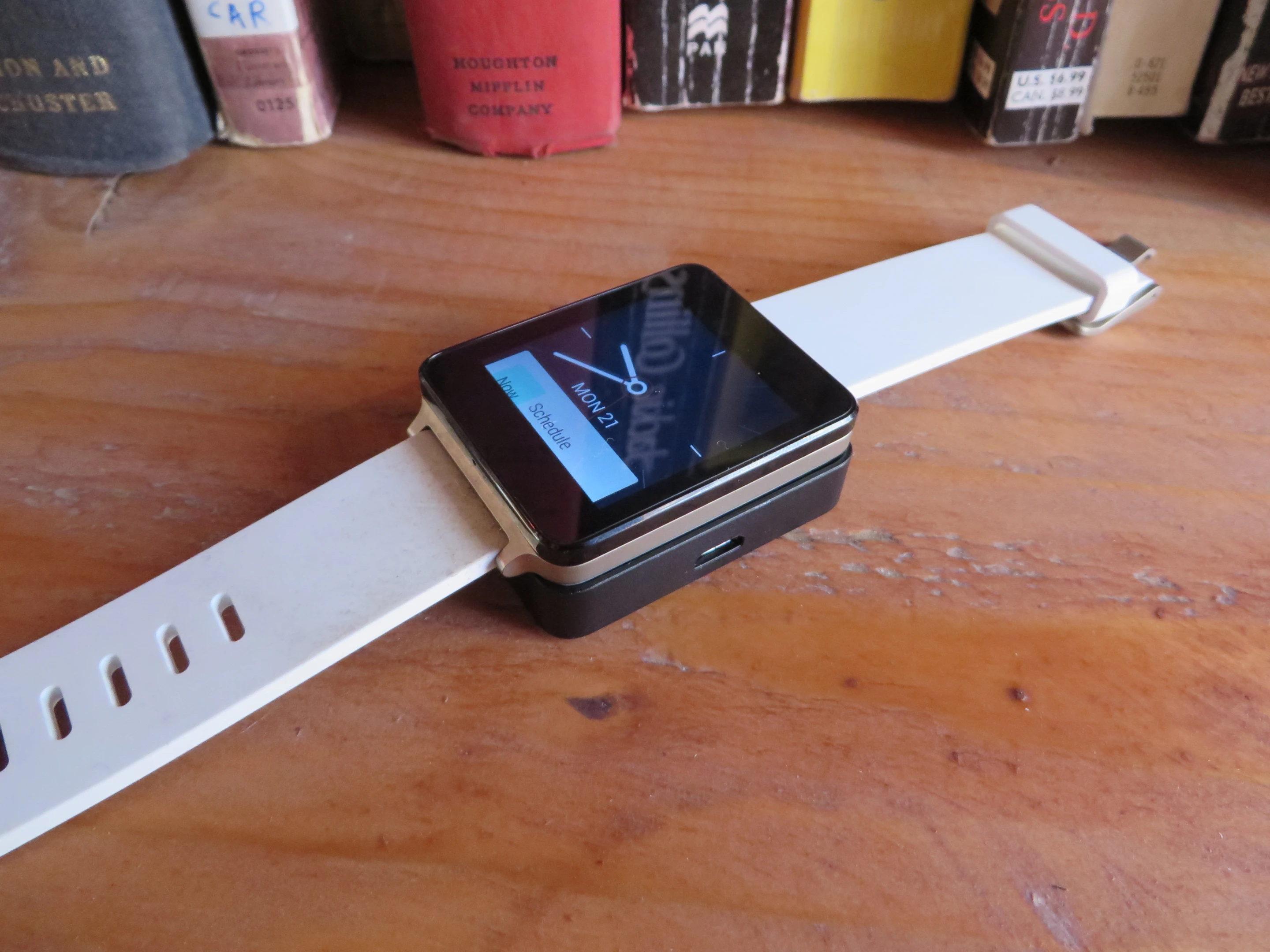 The G Watch atop its charging station, sans USB cord