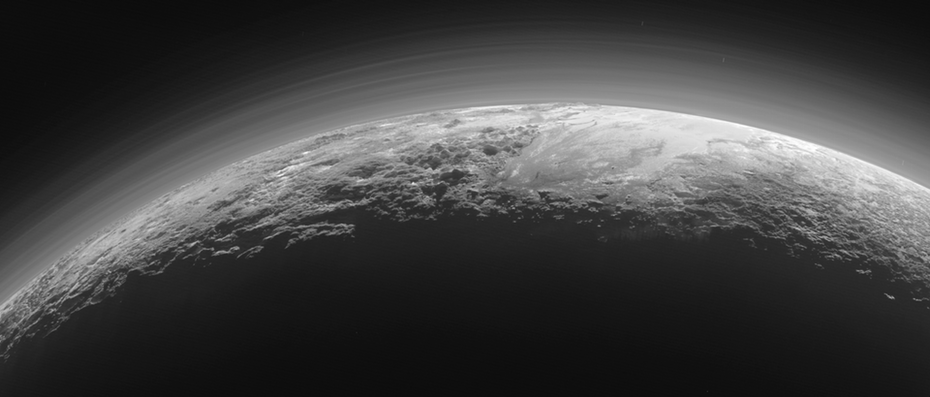 An image of Pluto's back-lit surface shot from a distance of 11,000 miles (18,000 km) by the New Horizons spacecraft