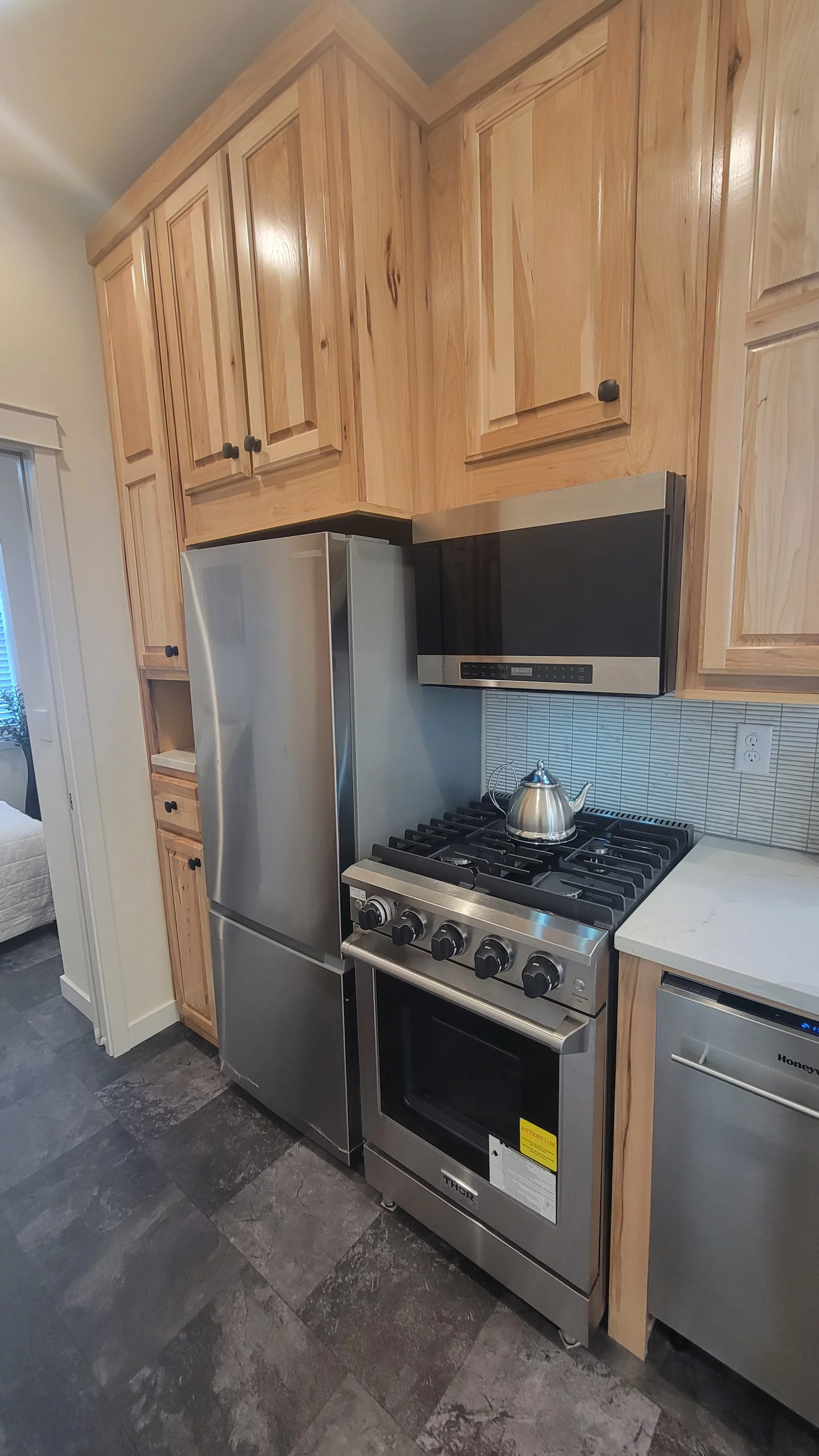 The Olivia Summit's kitchen includes an oven with propane-powered four-burner stove, a fridge/freezer, and a dishwasher