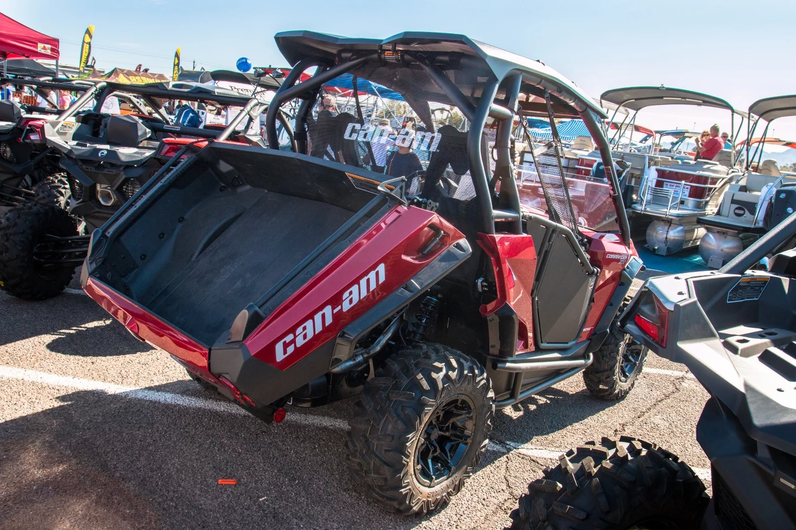 The Can Am Commander. Both sport and utility with a dual level cargo area featuring a tilt-assist cargo bed, shown here in action