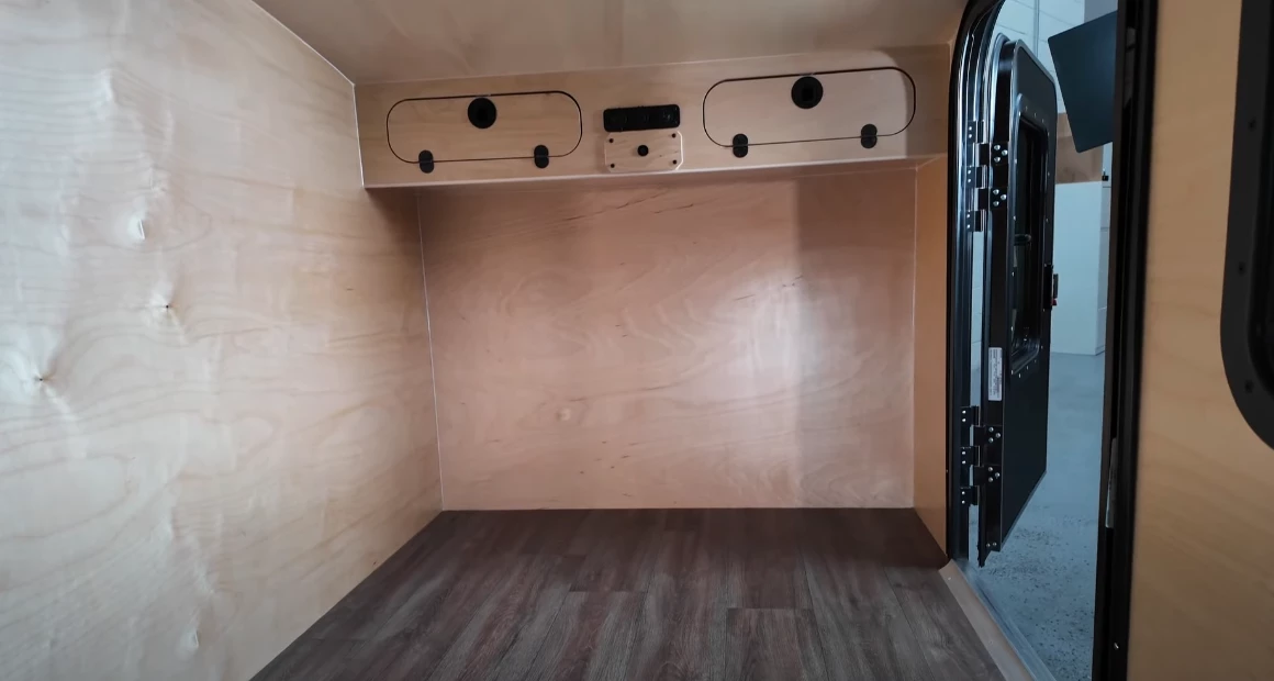 The front-end of the interior includes upper cabinets for a little bit of storage; the mattress is not included
