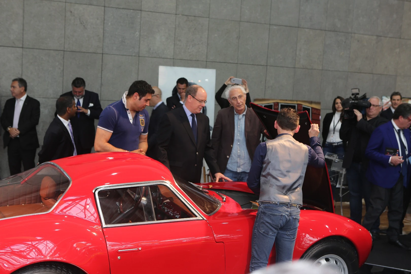 Prince Albert isn't leaving without taking a peek at that tuned Alfa Romeo engine