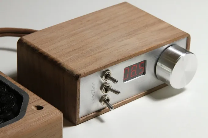 The device is crafted in stylish walnut wood casings