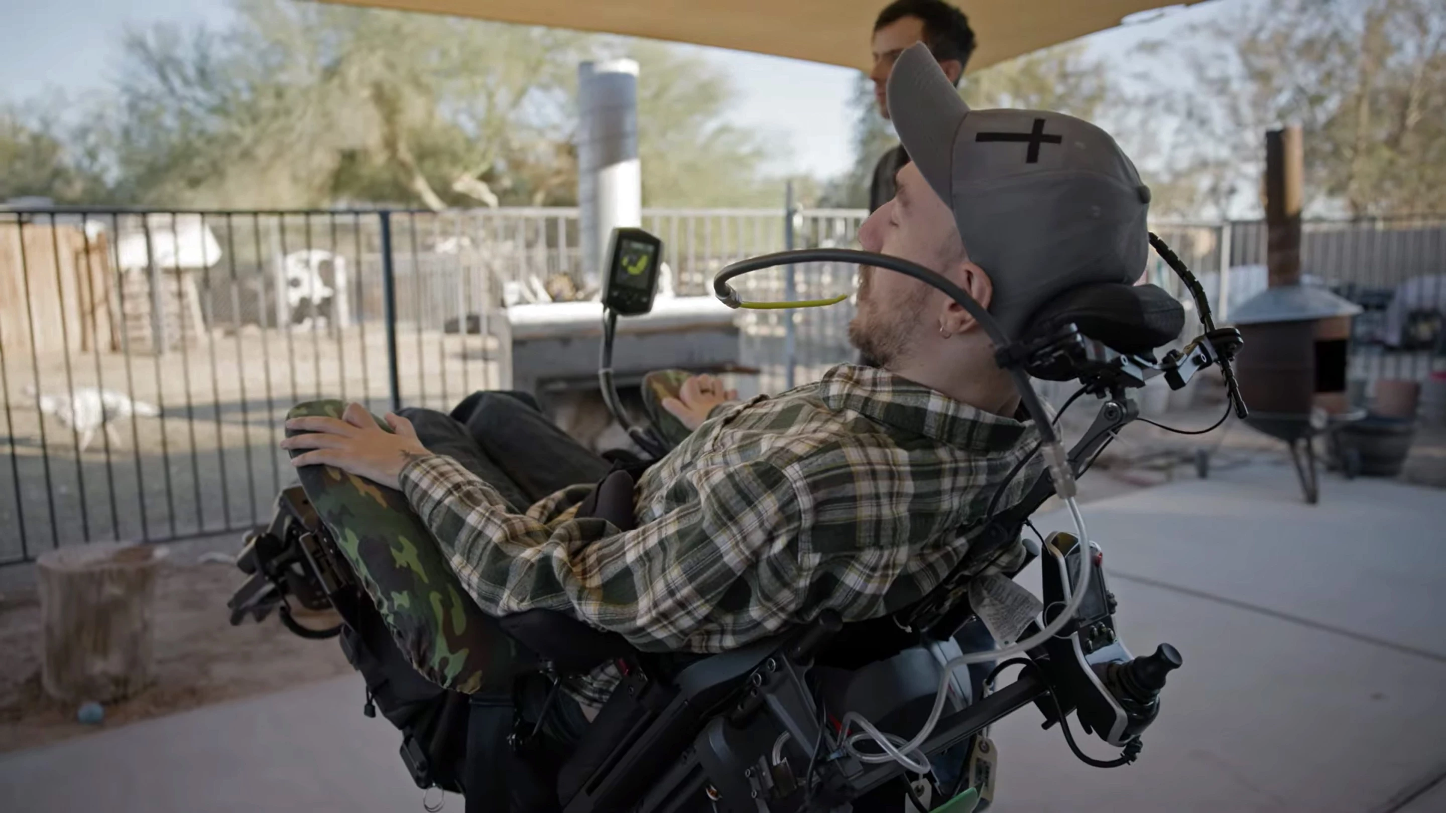 Neuralink's first human patient, Noland Arbaugh, at home in his wheelchair that he controls using his mouth