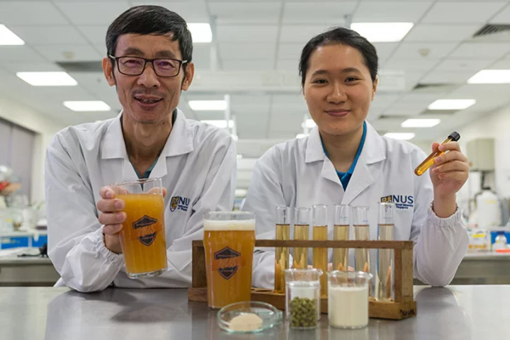 Associate Professor Liu Shao Quan (left) and Chan Mei Zhi Alcine (right), with their bacteria-filled beer