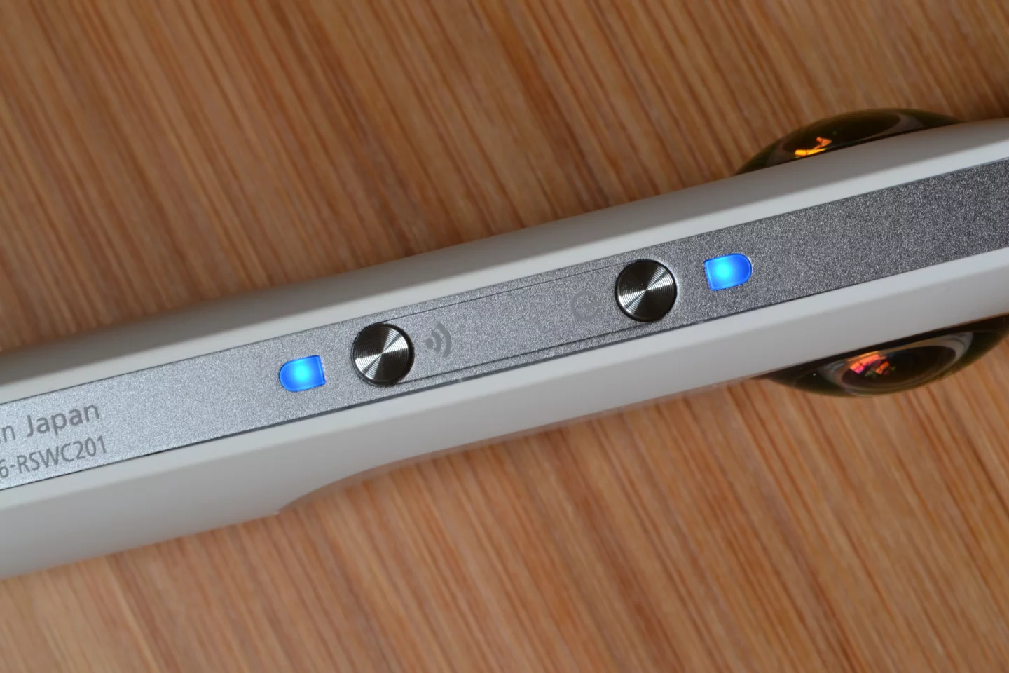 The power button (right) and the wireless connect button (left), both with LED status lights