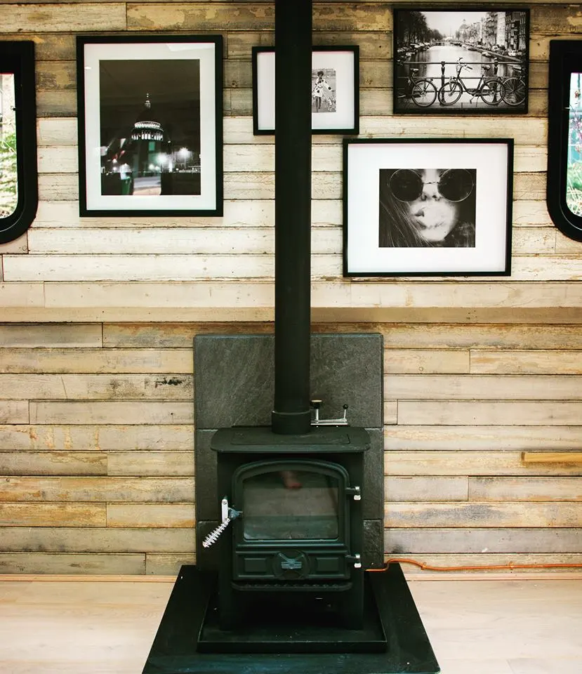 The houseboat features a log fire to keep guests warm on a cold and rainy day