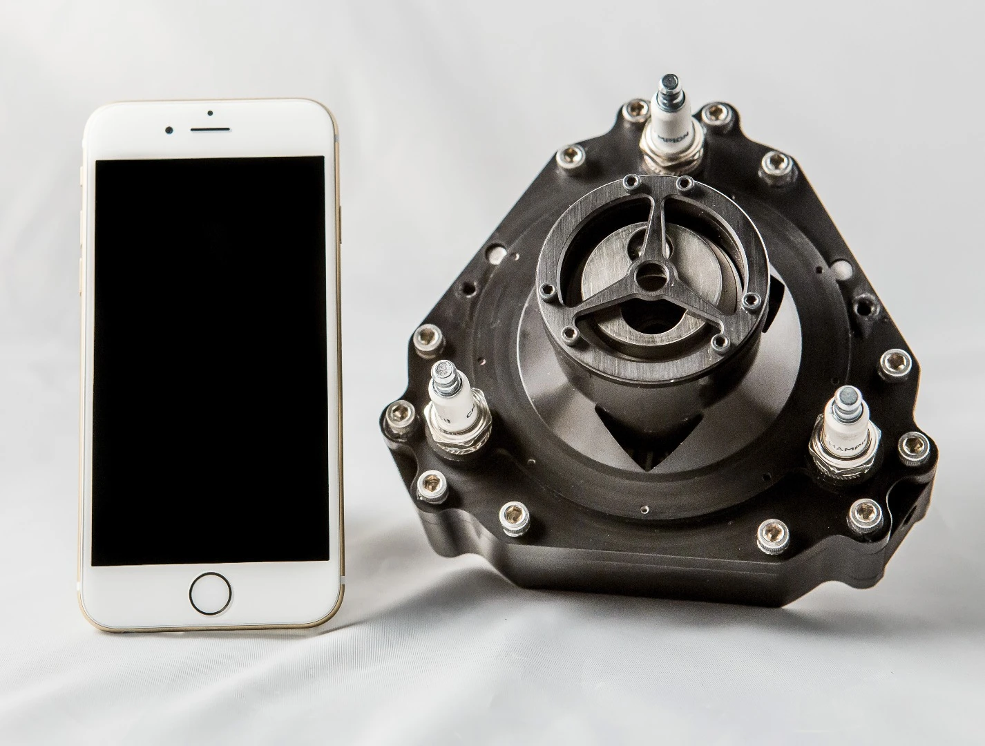 This tiny engine, compared here to an iPhone, outputs almost 3.5 horsepower
