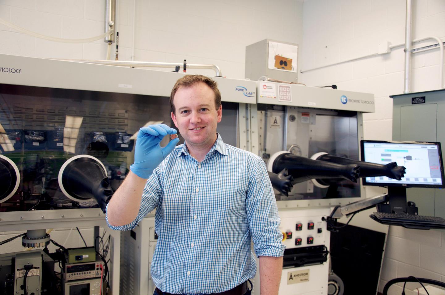 Associate Professor at the University of Toronto, Dwight Seferos, holds the vitamin B2 based cathode battery prototype