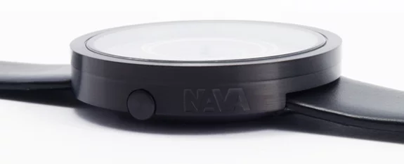 The black leather strap and stainless steel case offer a minimalist housing for the unique face