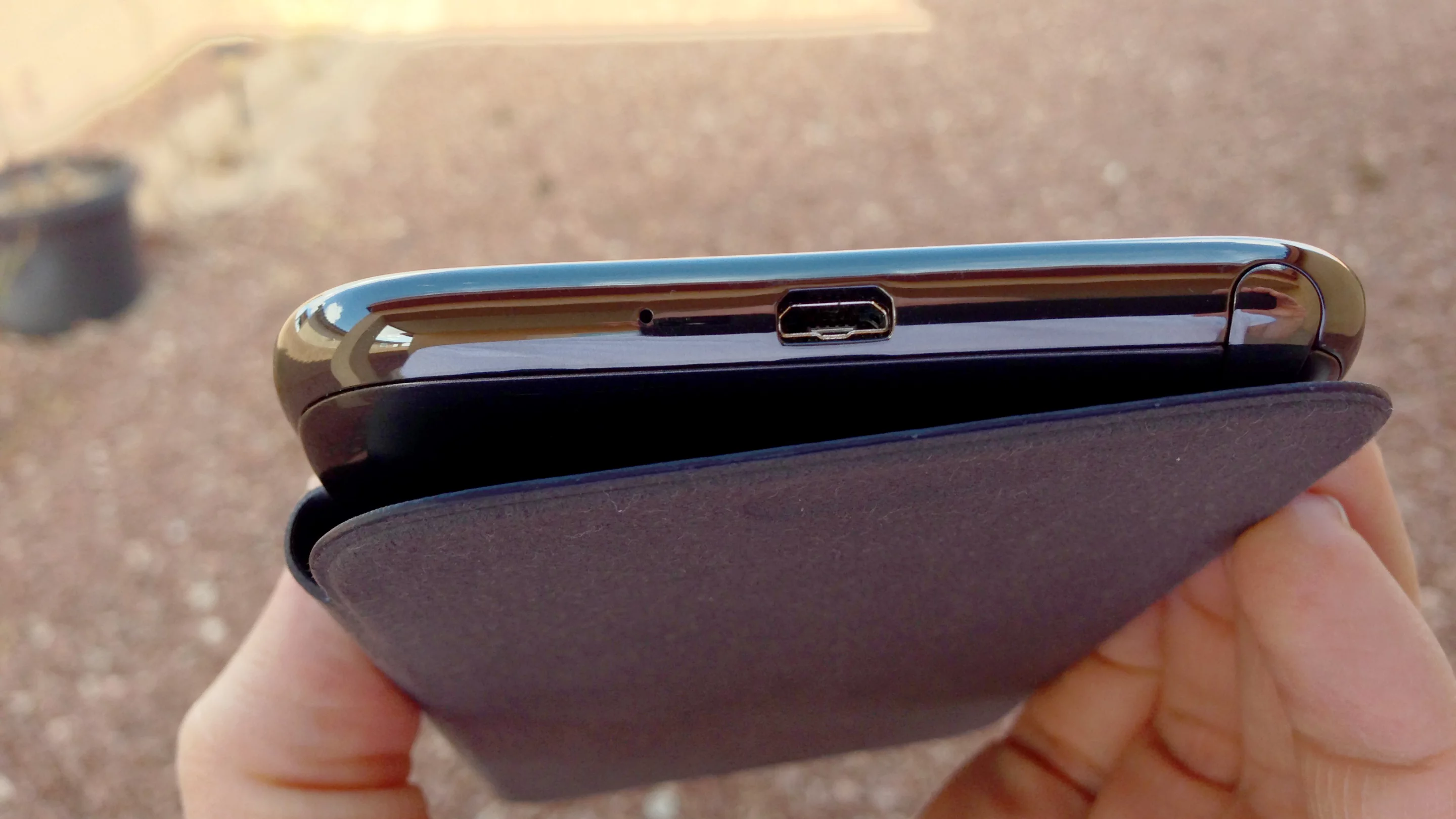 The Note II charges with a micro USB cable