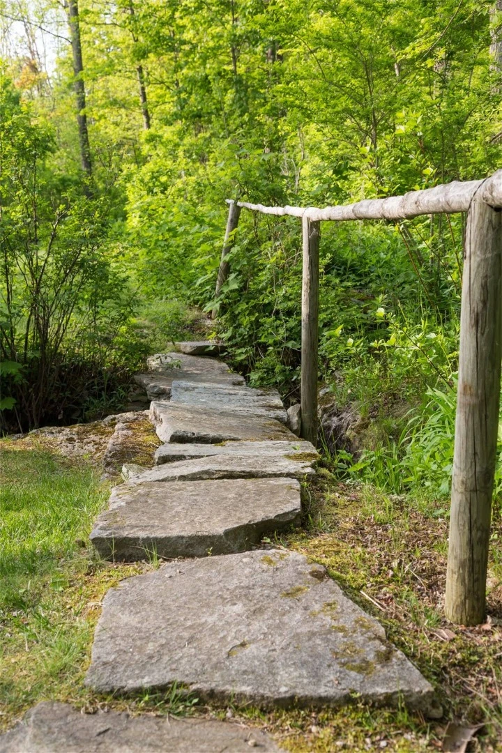 The four acre landscaped gardens surrounding the Tyringham Gingerbread House estate boast bridges, brooks and blossoms