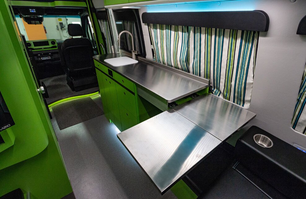The dining table slides and folds out from below the countertop, doubling as a counter extension