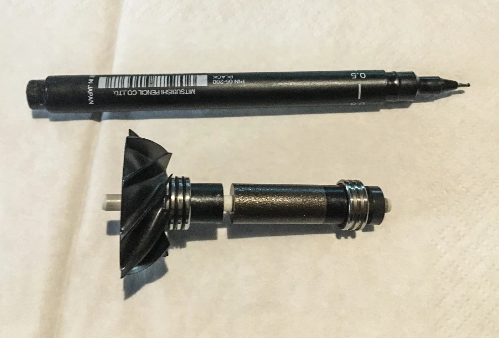 The tiny ceramic shaft and impeller from the V10 motor