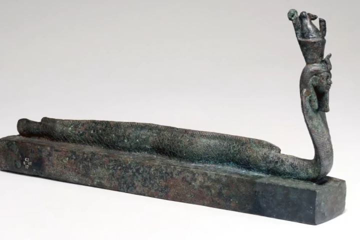 The coffin adorned with the human-headed part-eel, part-cobra imagery linked to Egyptian god Atum