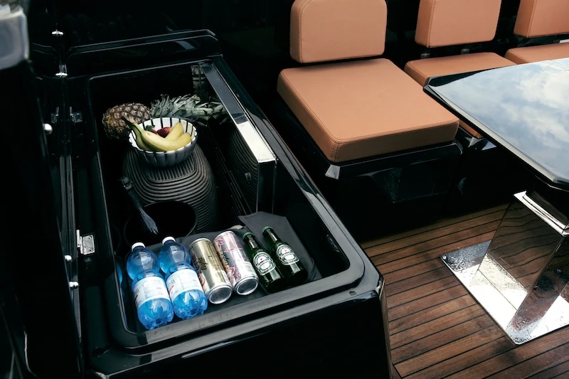 A large icebox sits below the captain's seat