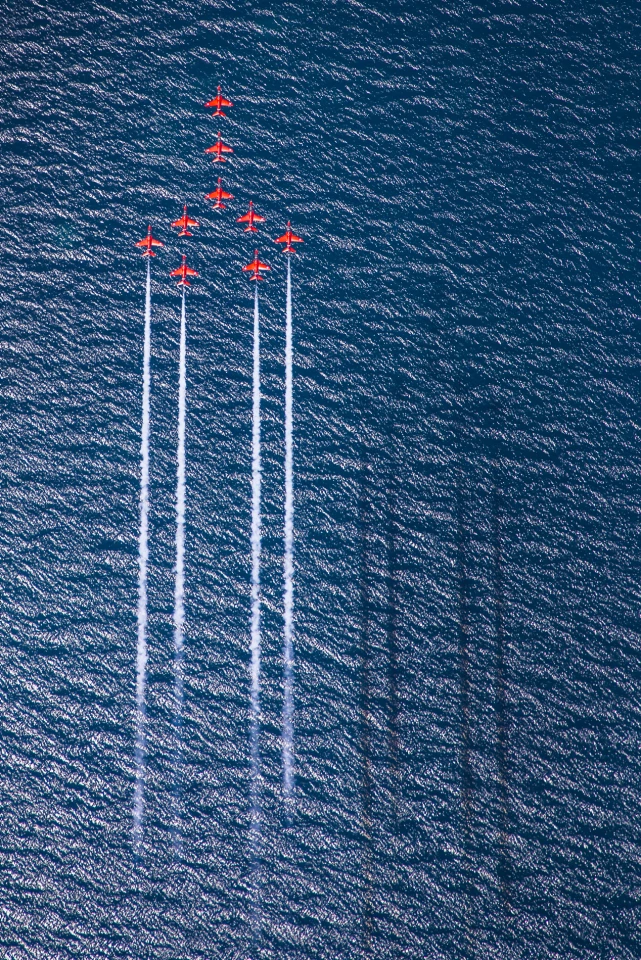 Winner of the RAF Image of the Year. The Royal Air Force Aerobatic Team, the Red Arrows perform Concorde over the deep blue sea of Greece.