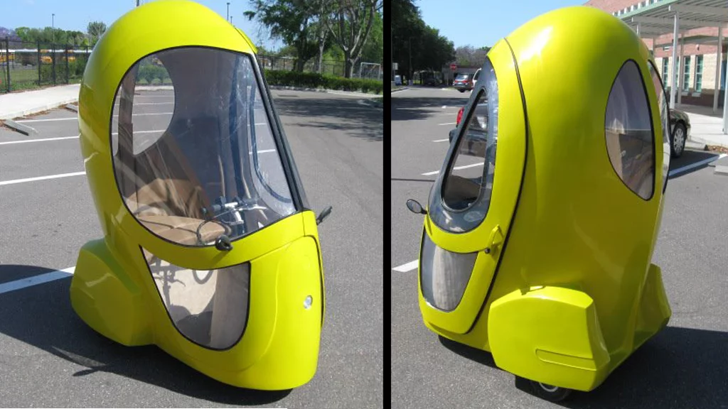 The Eggasus is a three-wheeled electric vehicle fitted with an electric hub motor, enclosed cab, tinted windows, a seat, and instrument display panel