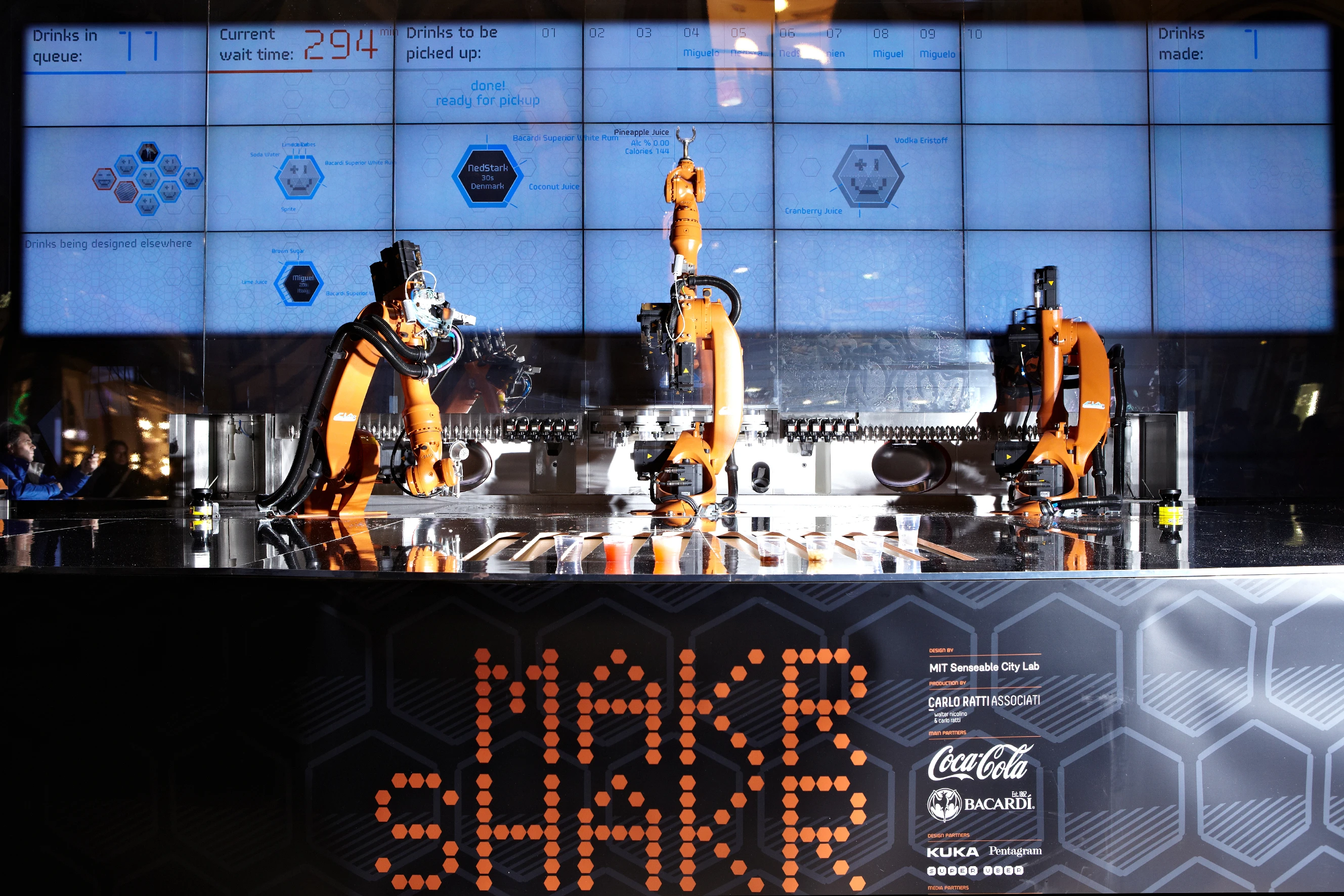 A display shows the status of the robots
