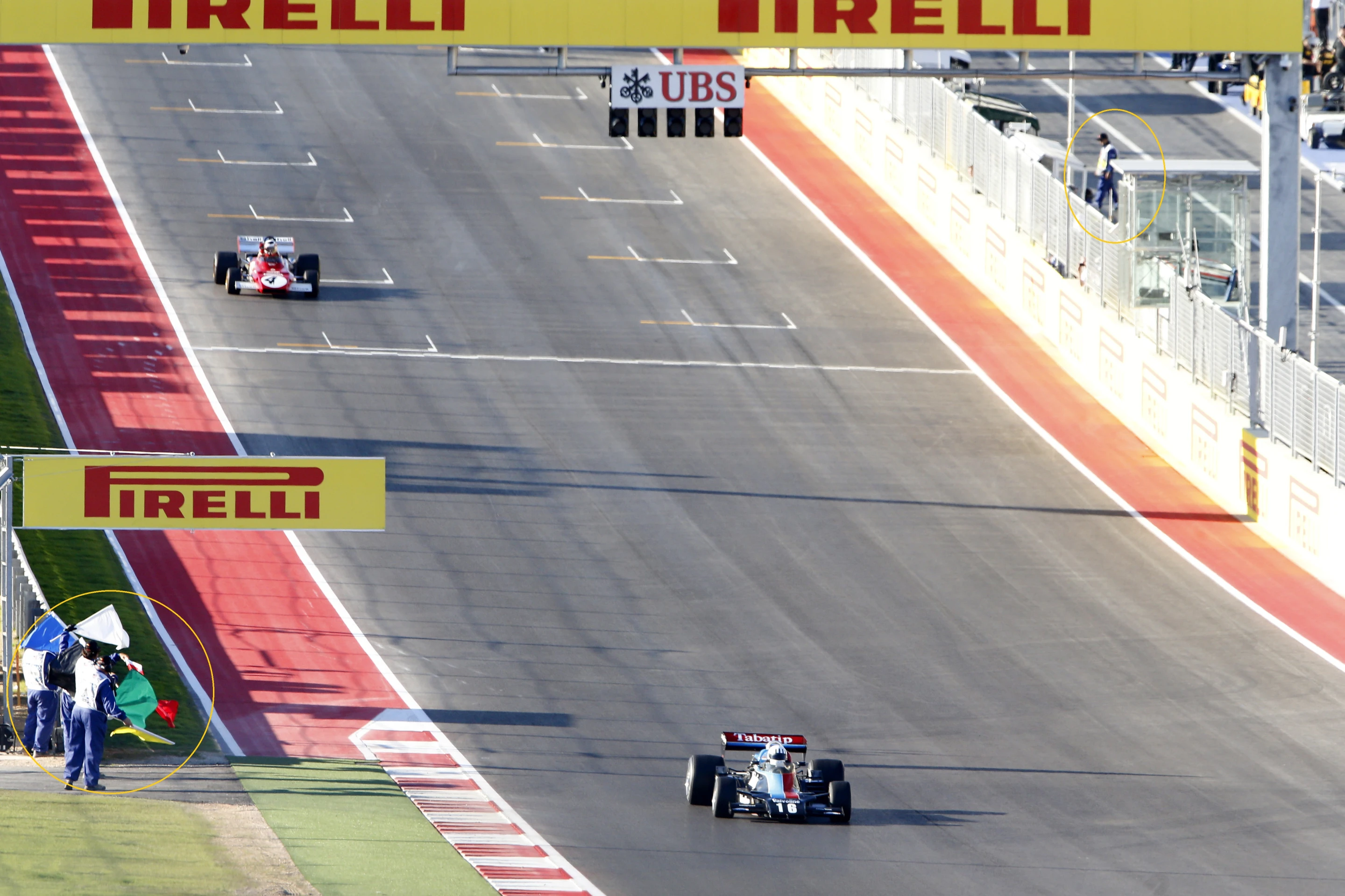 Here the corner workers (circled) salute the drivers at the end of one of the support races on F1 weekend - a vintage formula car race (Photo: Circuit of the Americas)