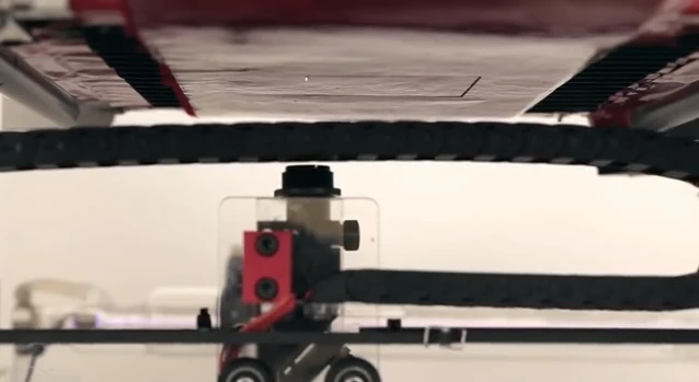 A laser in the fabric printer burns shapes into material suspended by a vacuum (Photo: Disney Research)