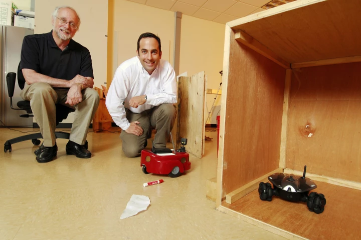 Prof. Ronald Arkin (left) and research engineer Alan Wagner with their hide-and-seek-playing robots