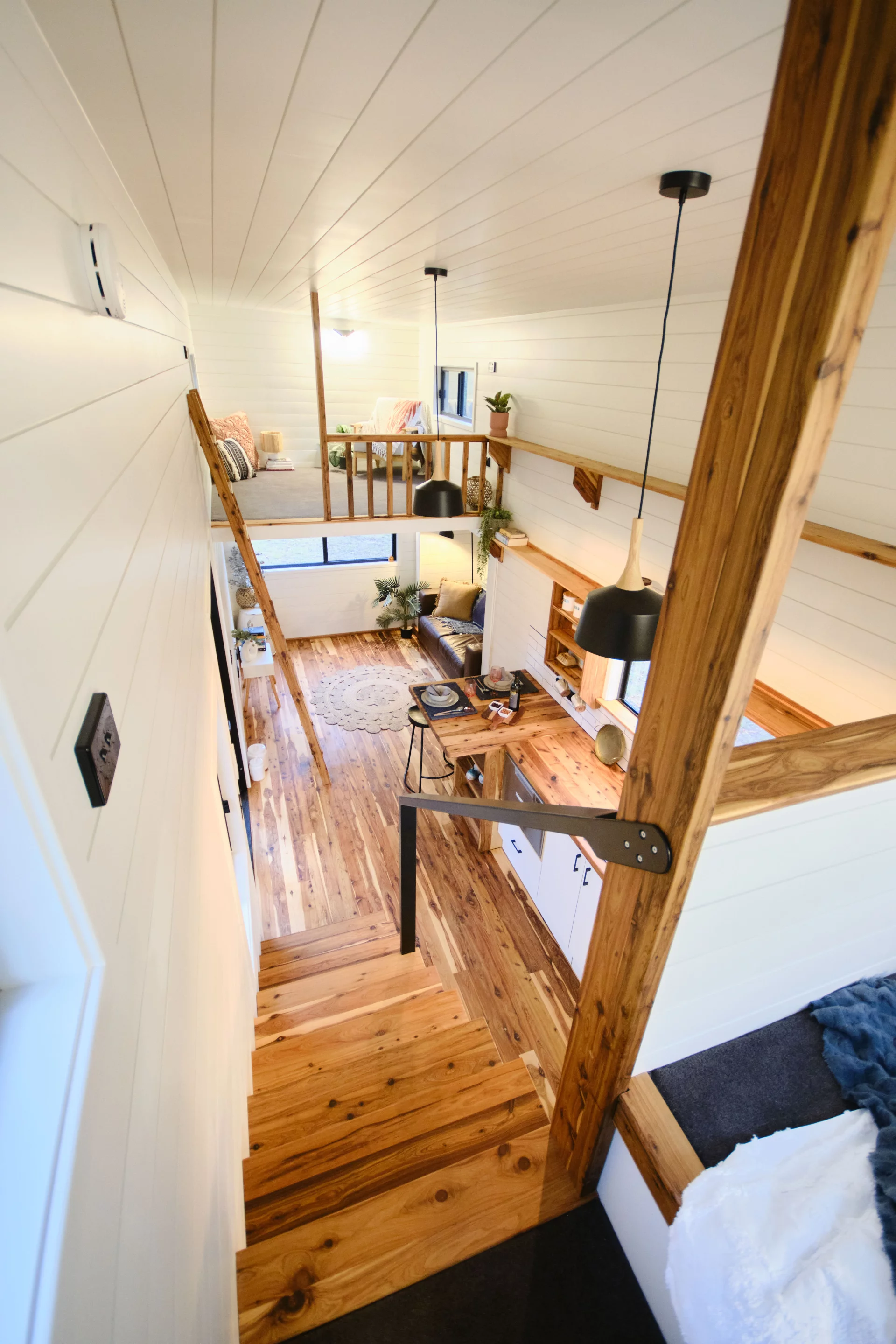 One of the Grand Sojourner Layout 3's loft bedrooms is reached by removable ladder, while the other is accessed by storage-integrated staircase