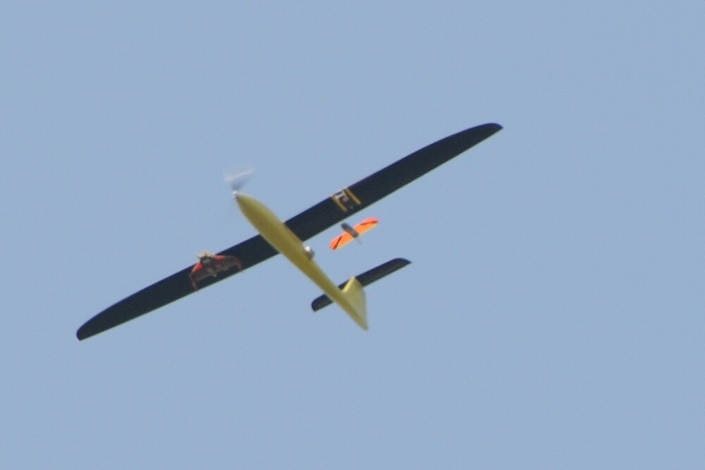 A Tempest UAV, releasing a CICADA UAV from under its left wing