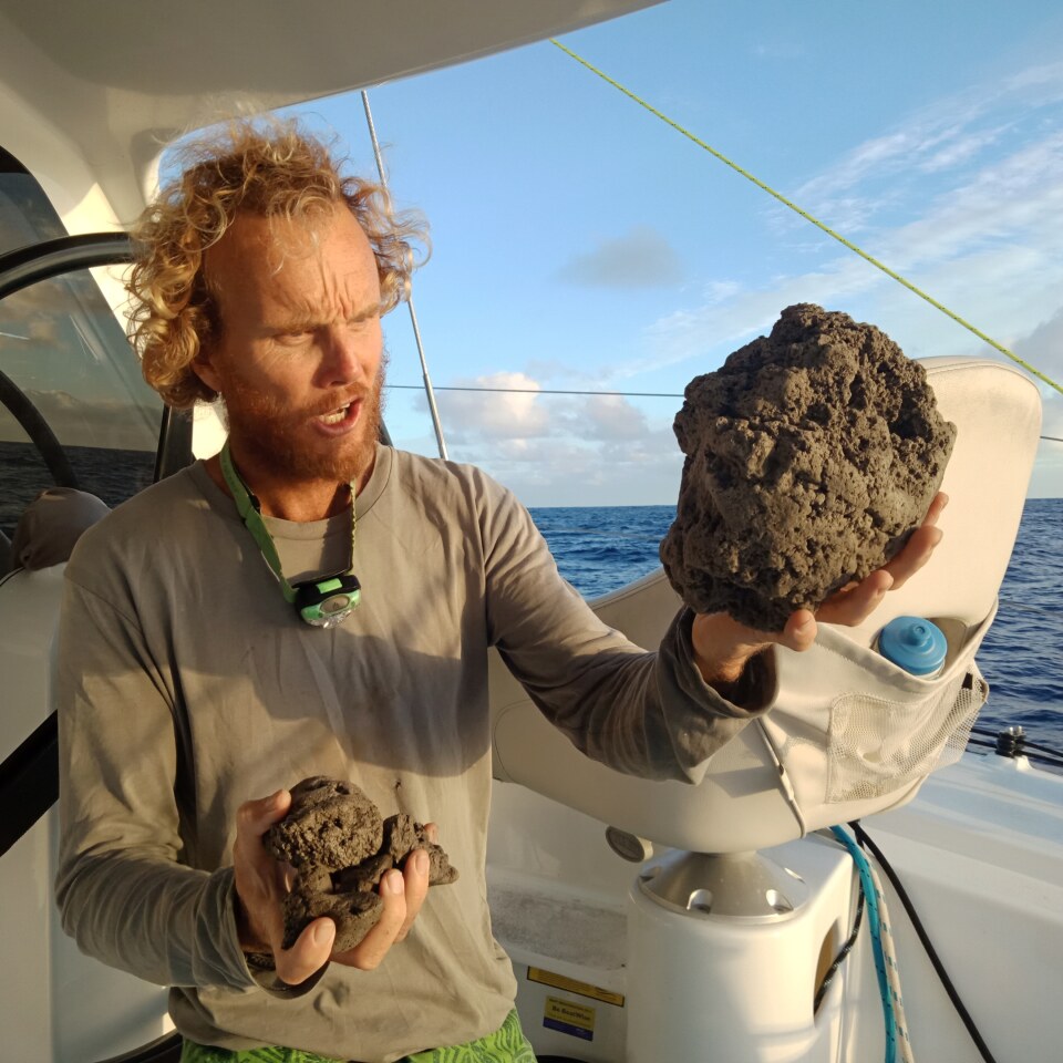 Sailor Michael Hoult holding samples of the pumice