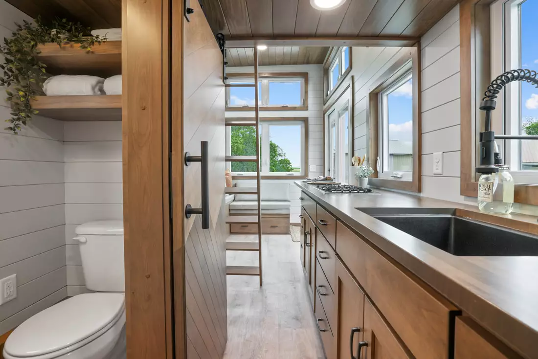 The Pathway's kitchen offers access to the bathroom with a sliding door