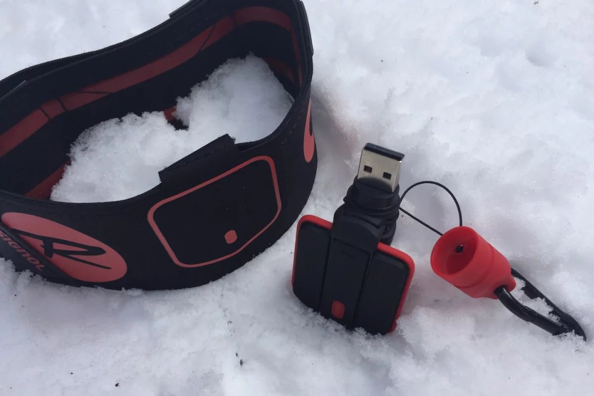 The Rossignol Piq ski sensor is made up of three components: the Piq sensor, a portable charging unit and an ankle strap