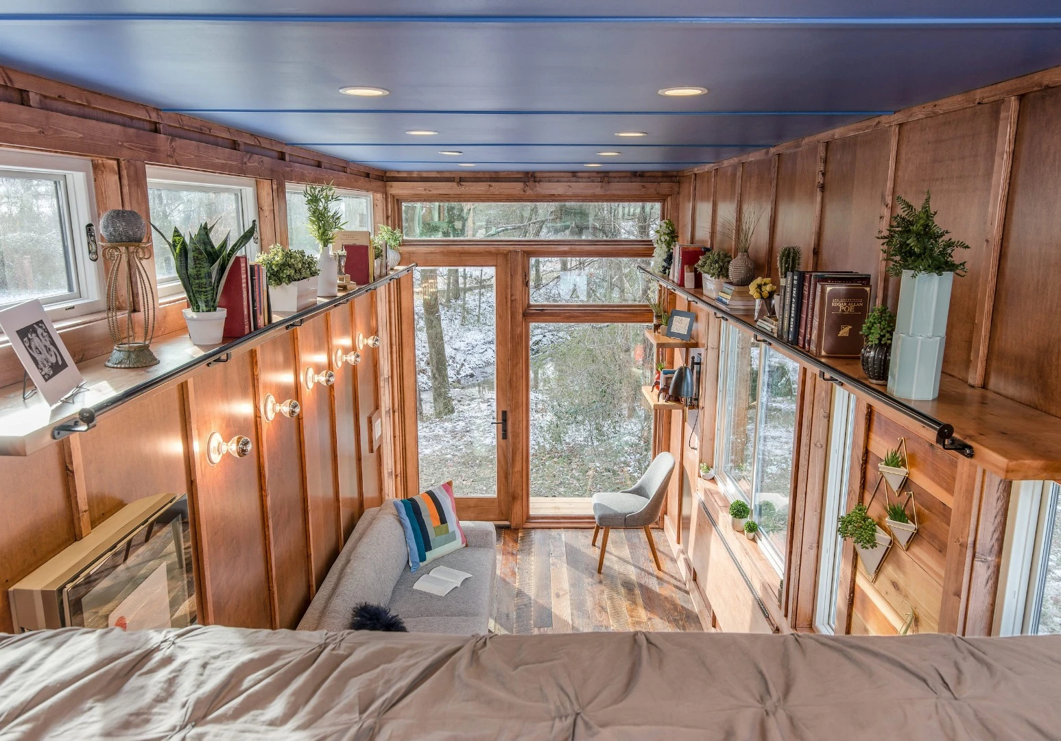 The Cornelia tiny house features reclaimed hardwood flooring, along with solid maple and maple plywood walls and ceiling inside