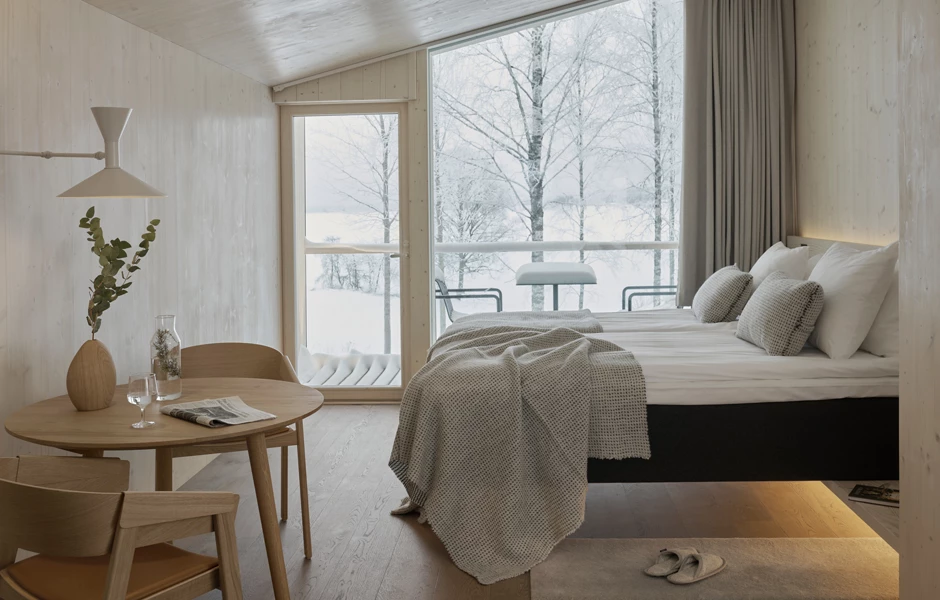 Each suite features warm timber materials and a floor-to-ceiling glass feature wall to capture the vast views across the forest