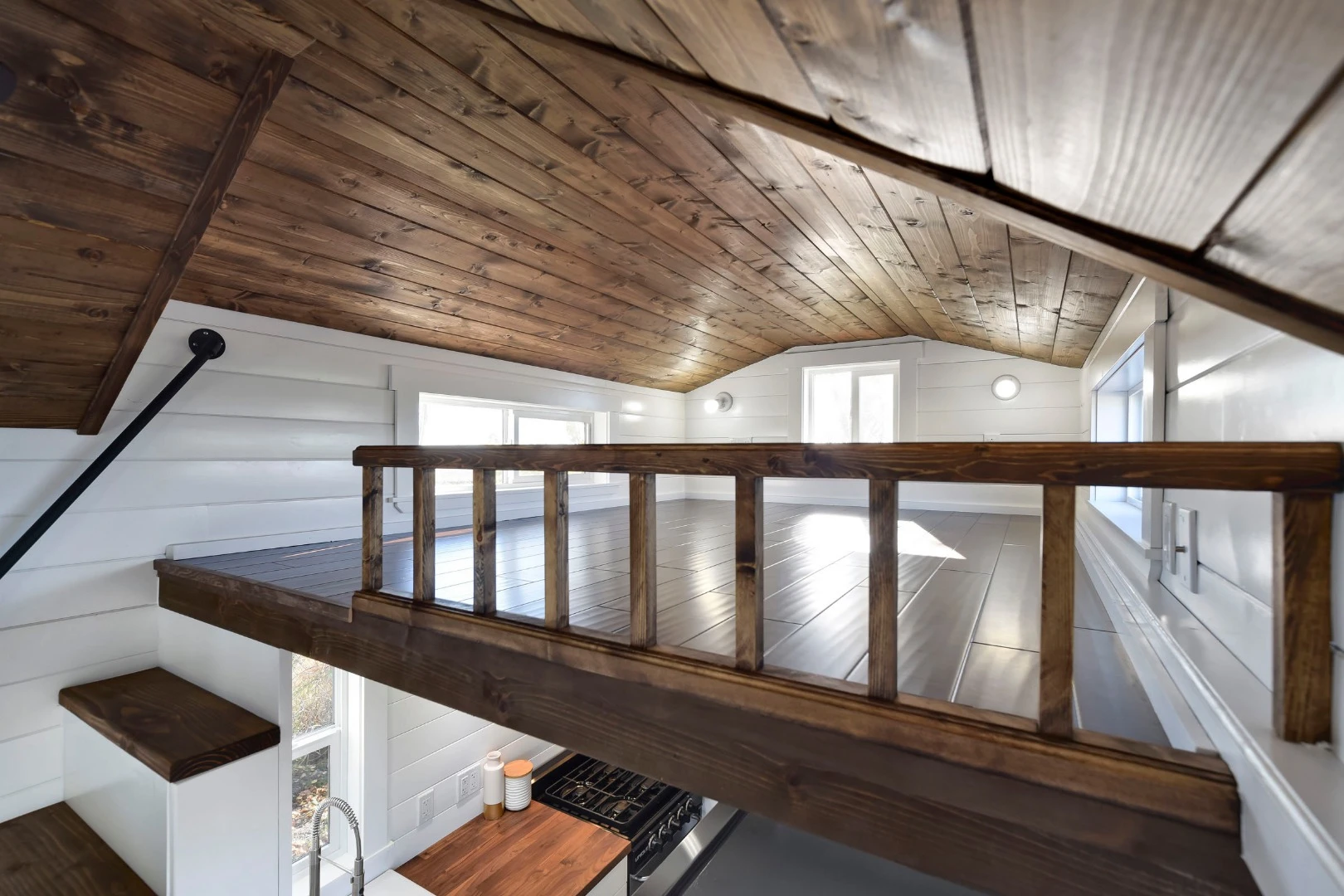 The loft bed features windows either side of the large double bed, to avoid the feeling of being enclosed or claustrophobic