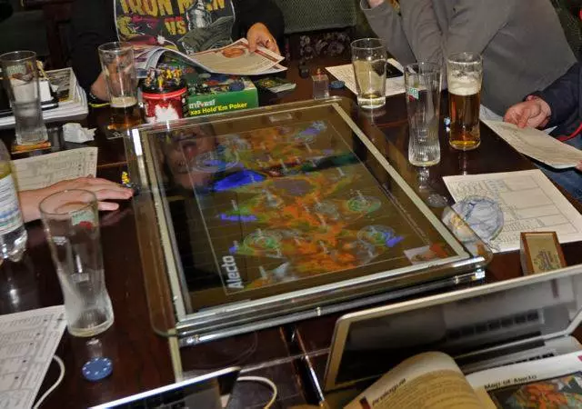 Using a connected laptop or smart device, gamers can set the GameChanger to display custom game boards and then lay it flat on a table, where other people can gather around and play