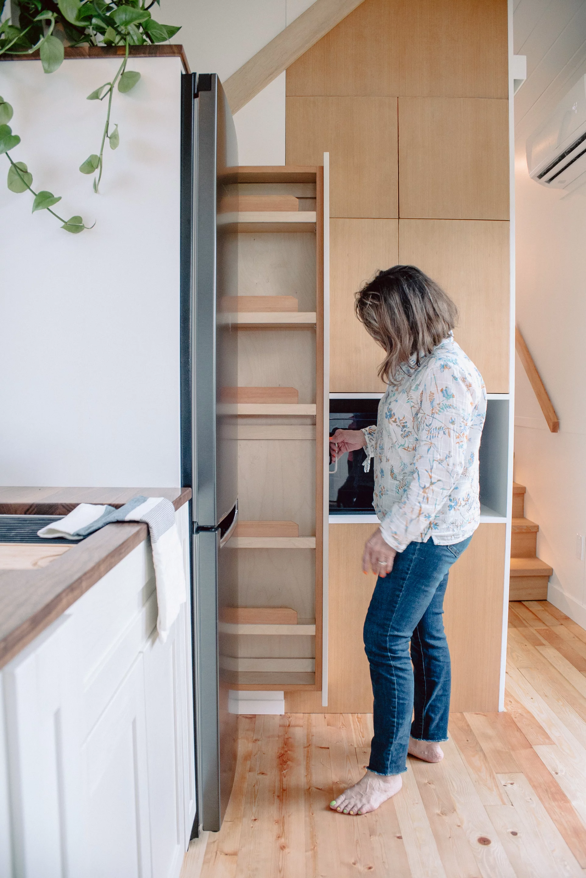 The Macdonald tiny house's kitchen has ample storage space, including a pull-out pantry