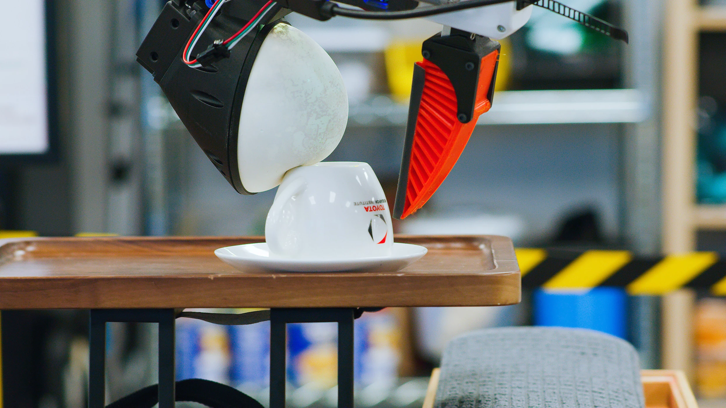 Tasks include complex 3D manipulations of different items, like turning teacups upside down without dropping or breaking them