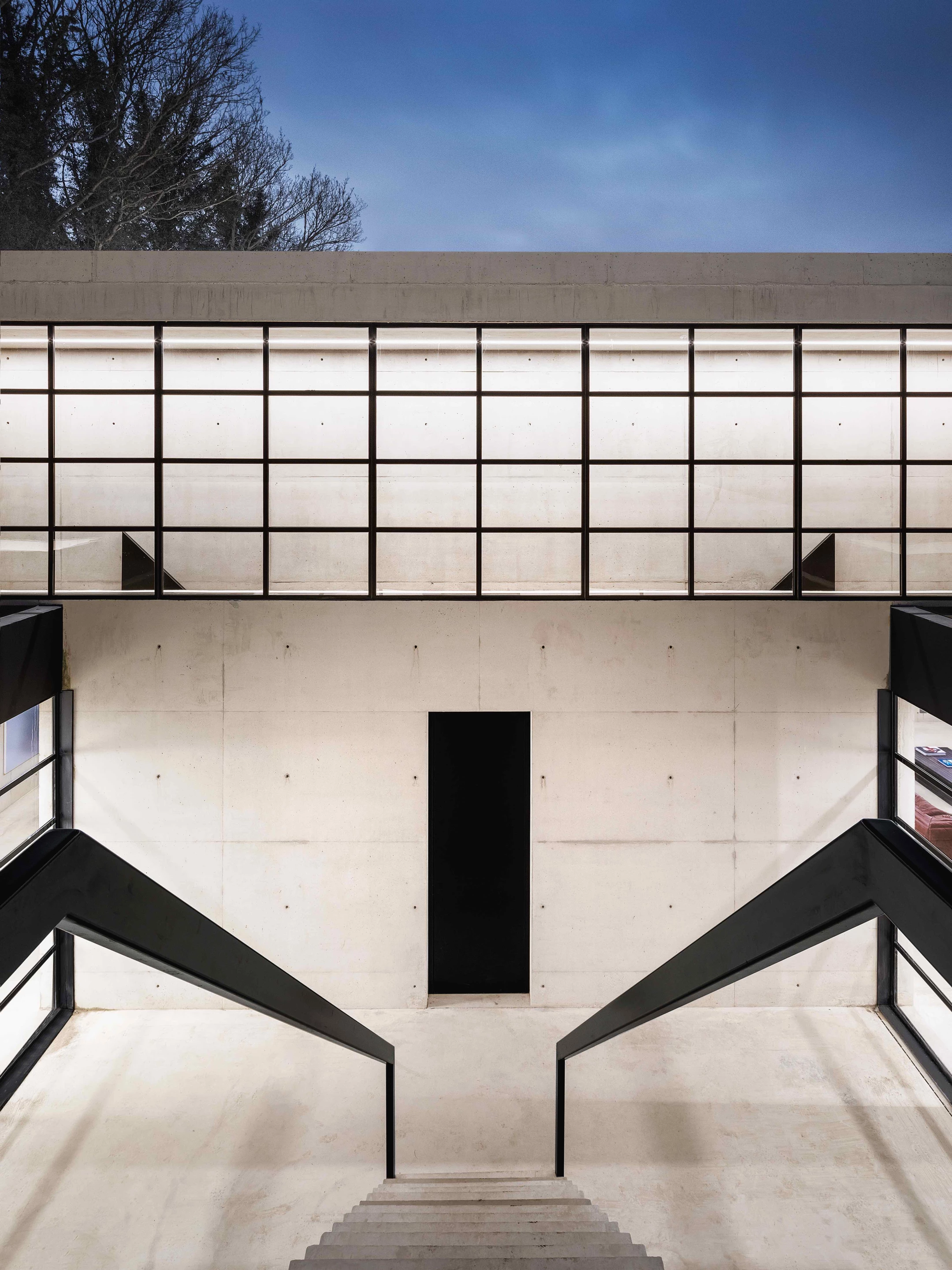 Visitors enter Ghost House through a slightly ominous-looking black steel door in its sunken courtyard area
