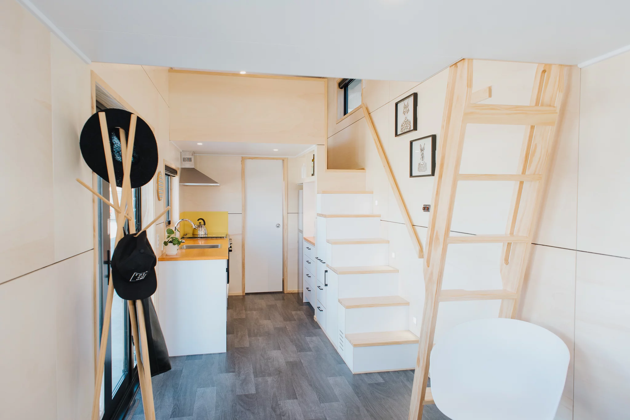 The Dreamweaver Tiny House has a storage-integrated staircase that also contains a propane-powered heating system